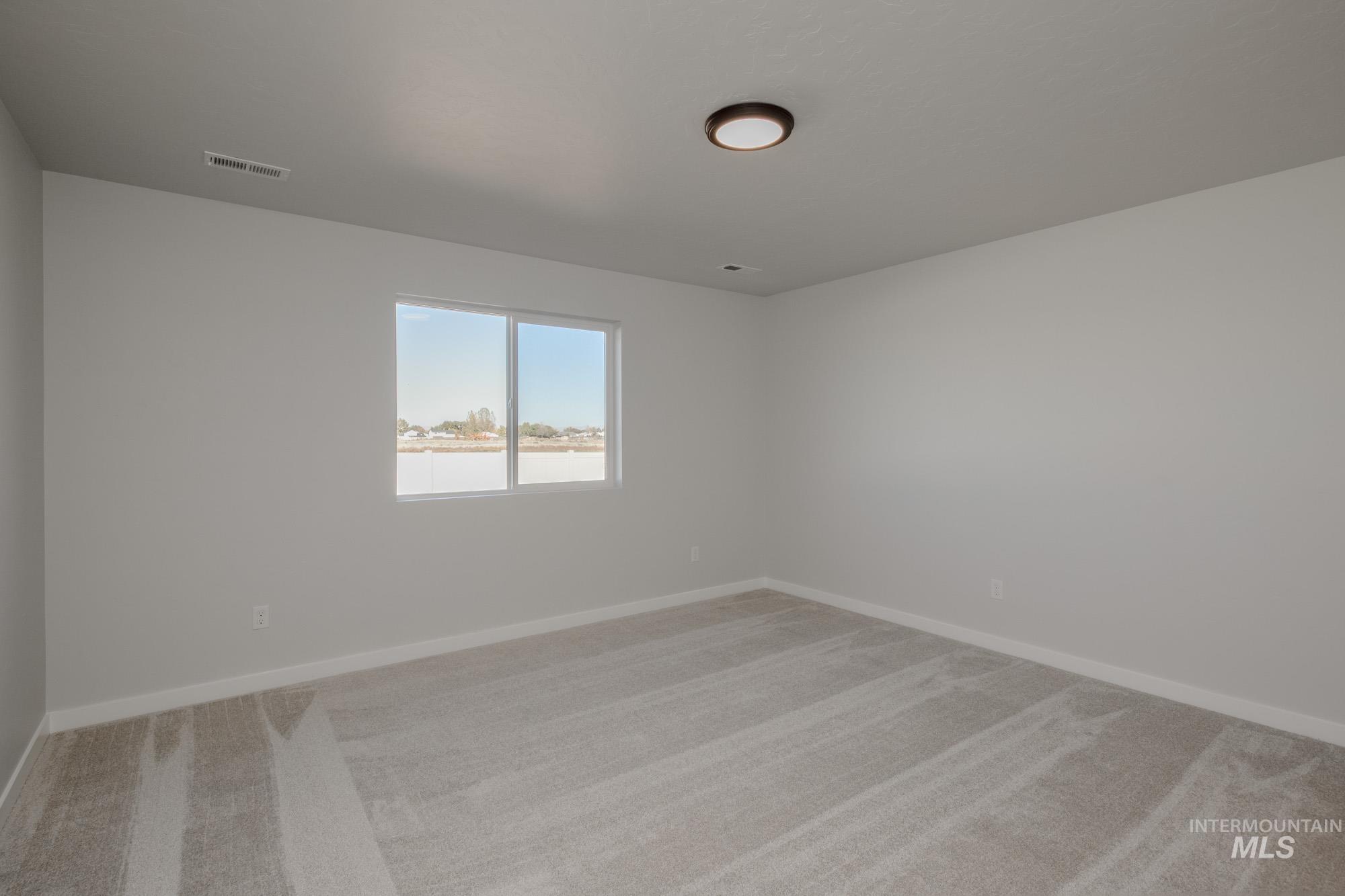 1609 Sunday River Street Middleton, ID 83644 - Photo 17 of 22 Unfurnished room with light colored carpet and baseboards