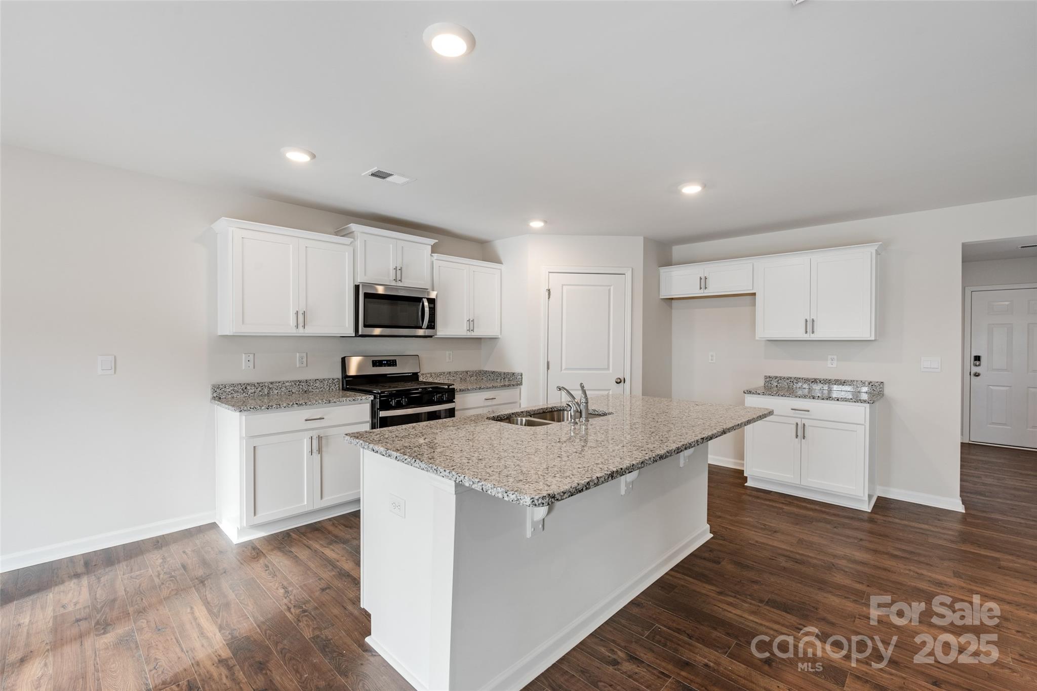 172 Callie River Clyde, NC 28721 - Photo 7 of 21 a kitchen with stainless steel appliances granite countertop a sink stove microwave and refrigerator