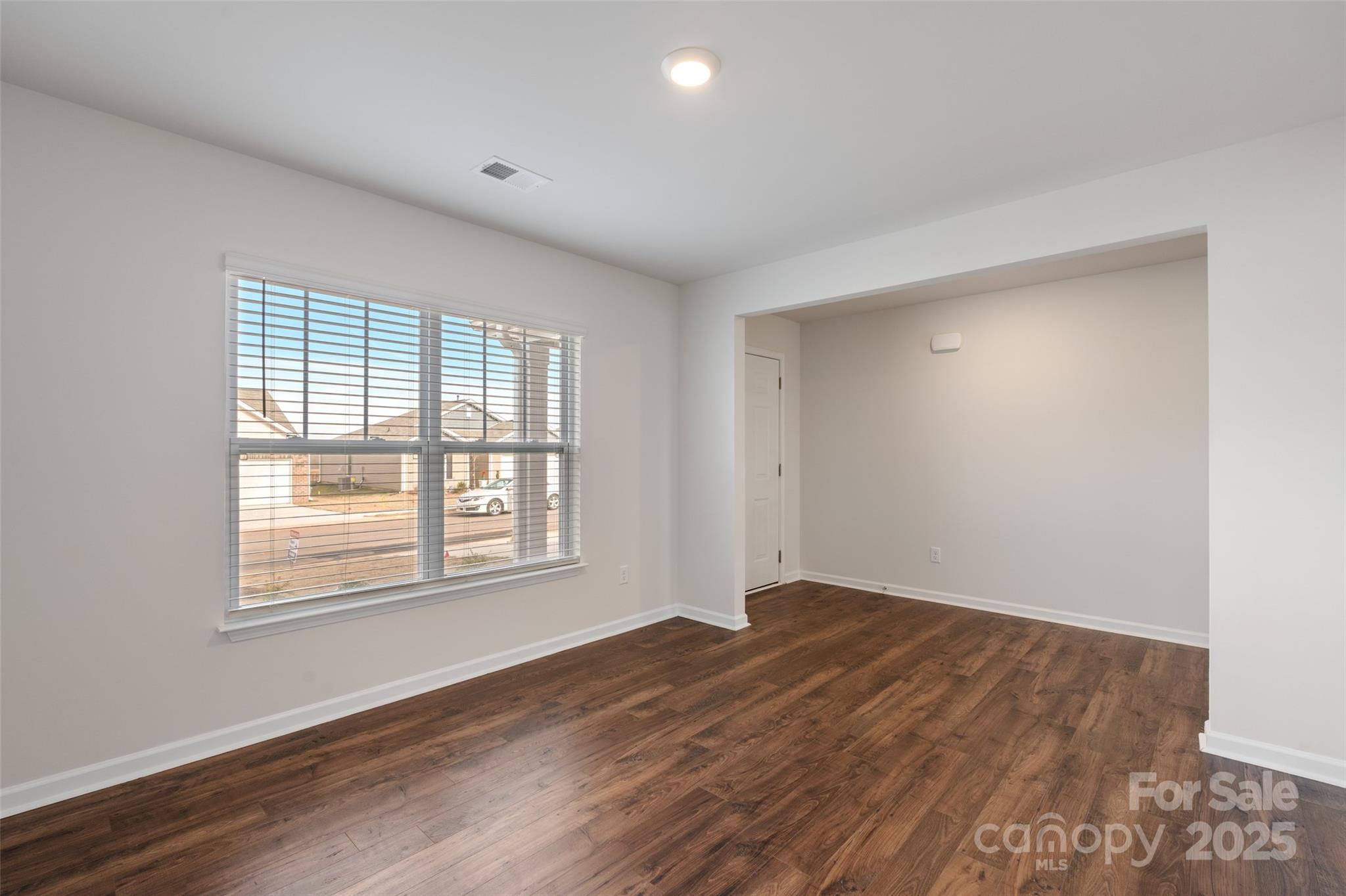 172 Callie River Clyde, NC 28721 - Photo 8 of 21 an empty room with wooden floor and windows