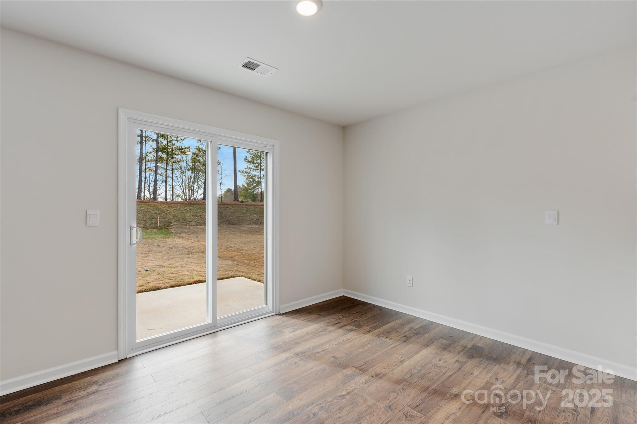 172 Callie River Clyde, NC 28721 - Photo 9 of 21 an empty room with wooden floor and windows