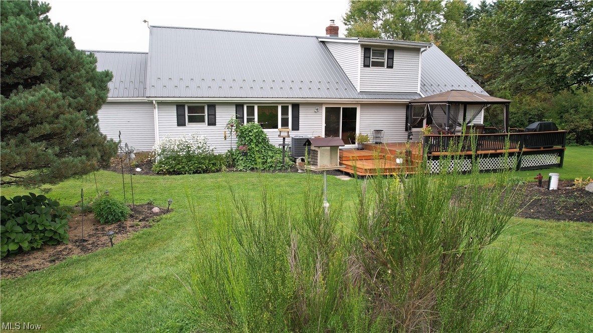 5712 Winchell Road Hiram, OH 44234 - Photo 31 of 31 Rear view of house featuring wooden deck and a lawn