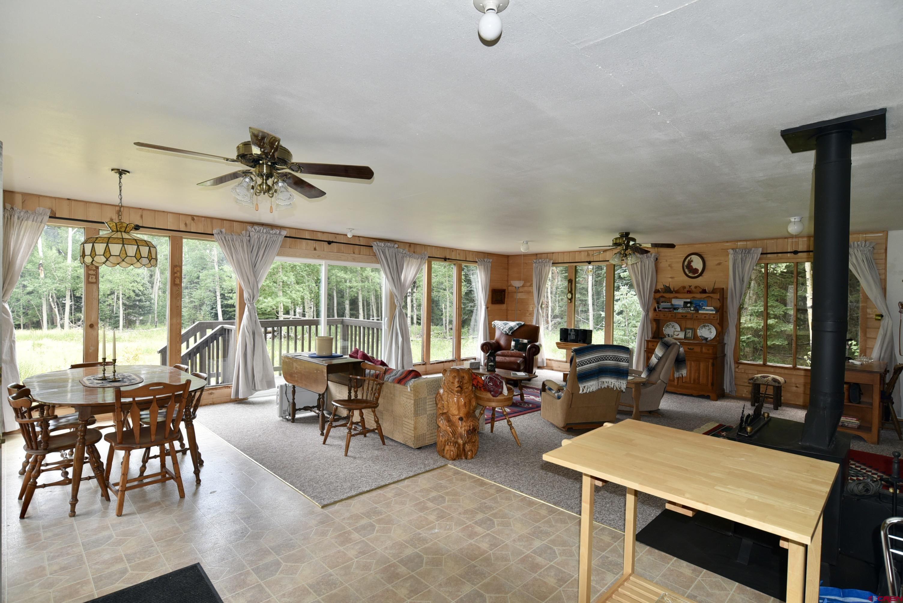 704 Hampton Road Montrose, CO 81220 - Photo 4 of 45 a living room with furniture ceiling fan and a large window