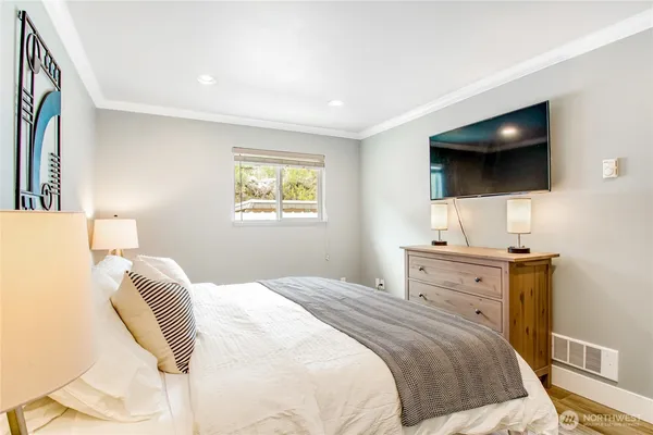 a bedroom with a bed and a flat screen tv