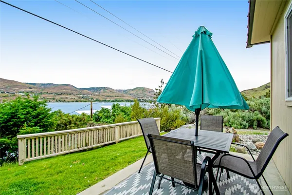 a view of backyard with a table and chairs