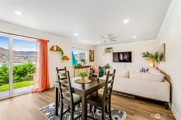 a living room with furniture and a floor to ceiling window