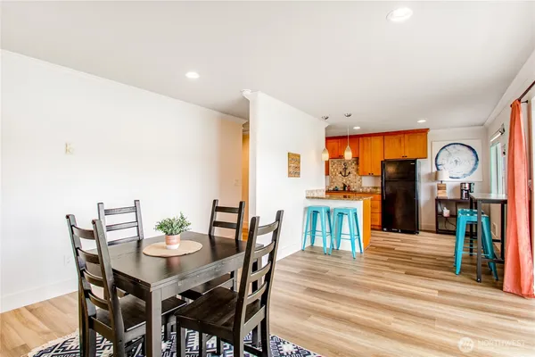 a dining room with furniture and wooden floor