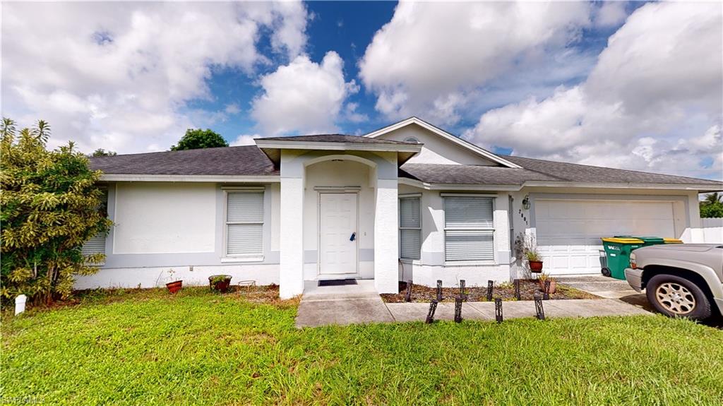 2801 46th Street Southwest Naples, FL 34116 - Photo 1 of 50 Ranch-style home with a garage and a front lawn