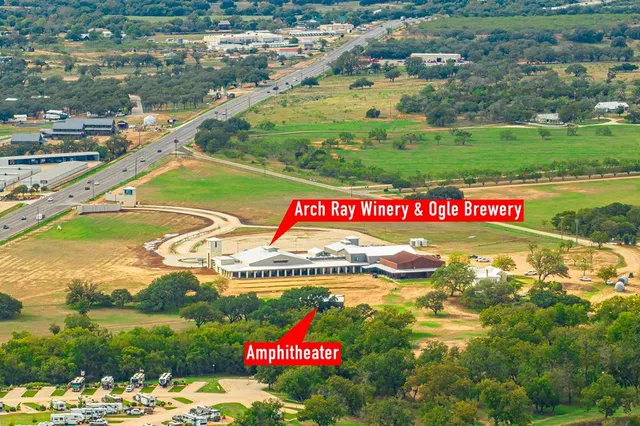an aerial view of residential houses with outdoor space and swimming pool