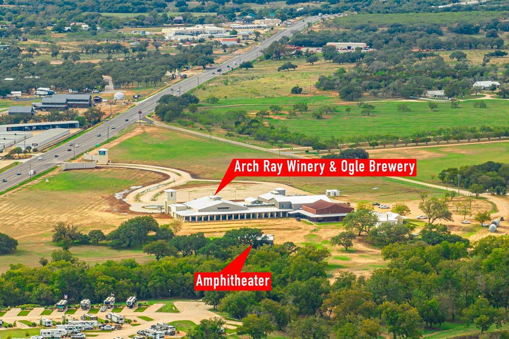 an aerial view of residential houses with outdoor space and swimming pool