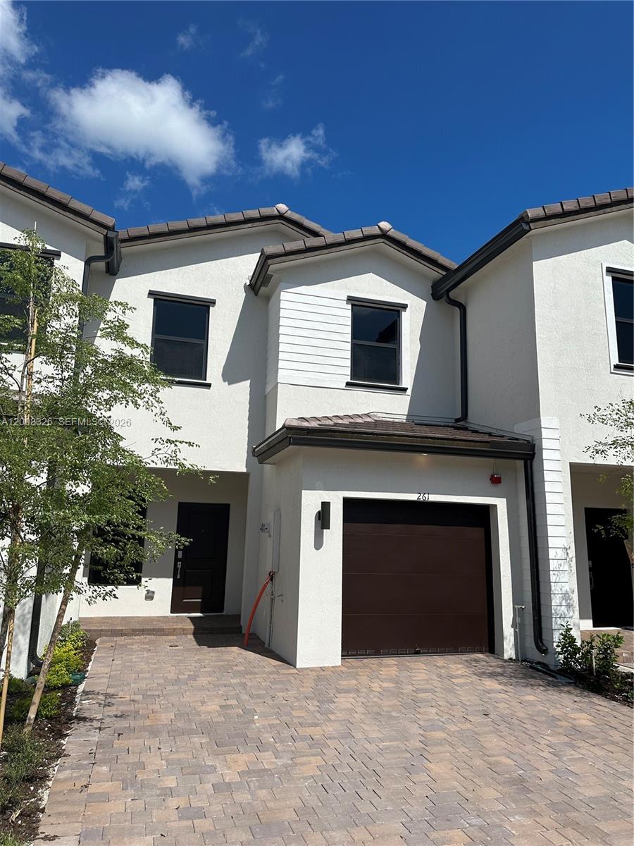 261 Southwest 159th Way Pembroke Pines, FL 33027 - Photo 1 of 17 a front view of a house with a garden