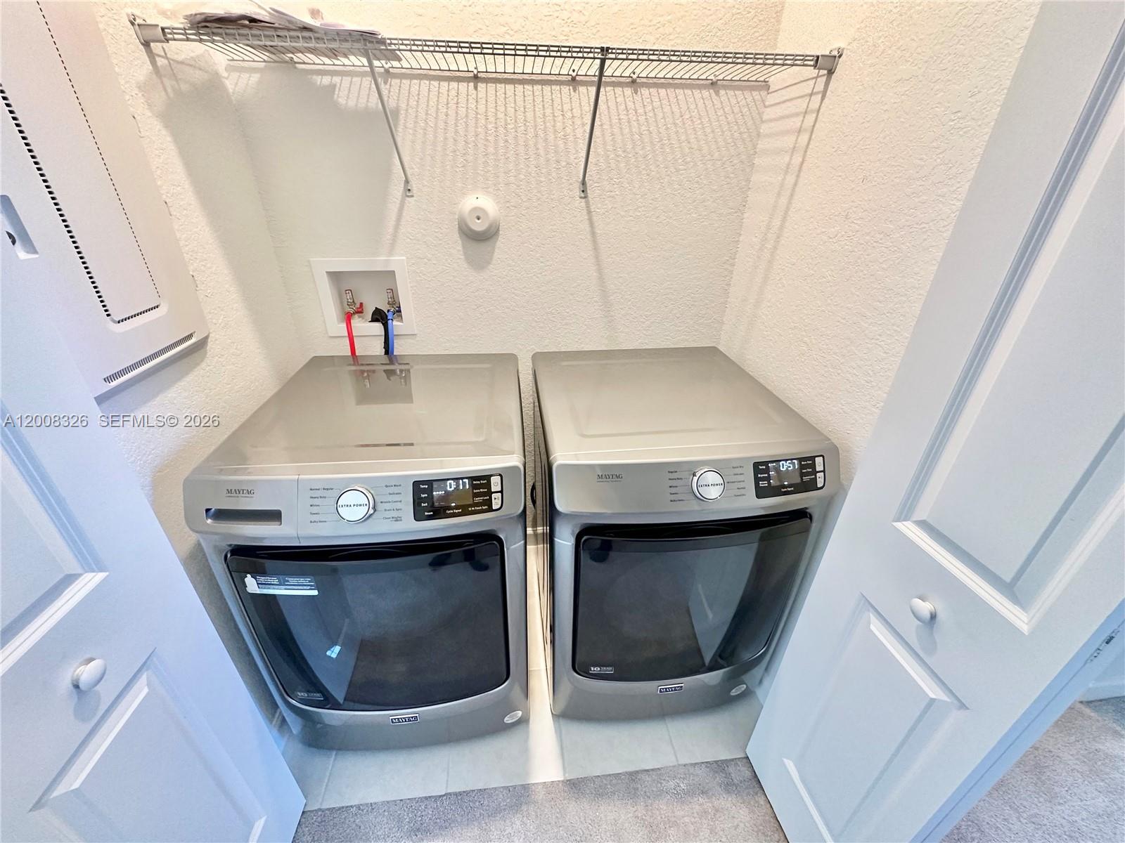 261 Southwest 159th Way Pembroke Pines, FL 33027 - Photo 12 of 17 a bathroom with a sink a washer and dryer