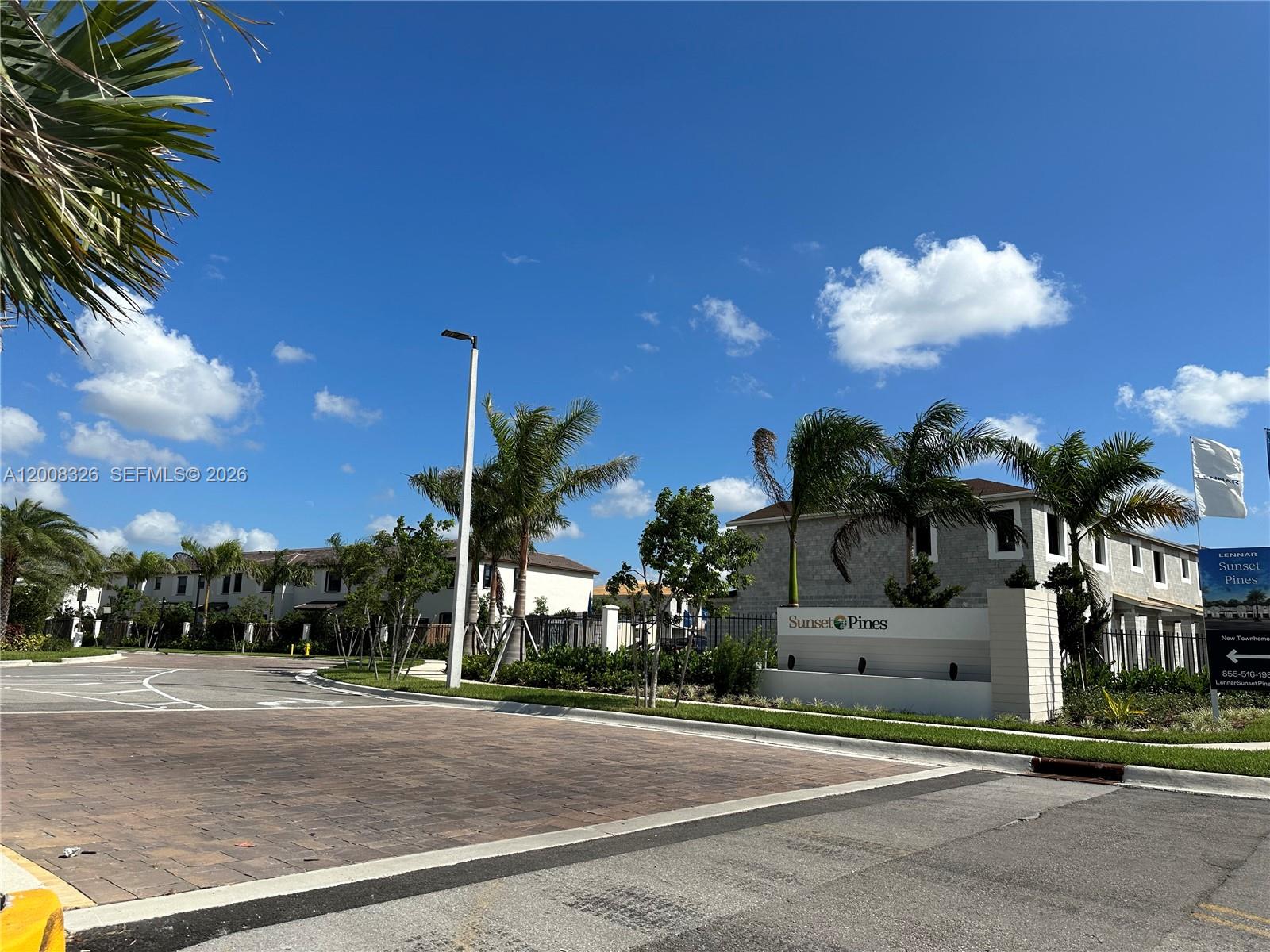 261 Southwest 159th Way Pembroke Pines, FL 33027 - Photo 16 of 17 a tall yellow building with trees in front of it