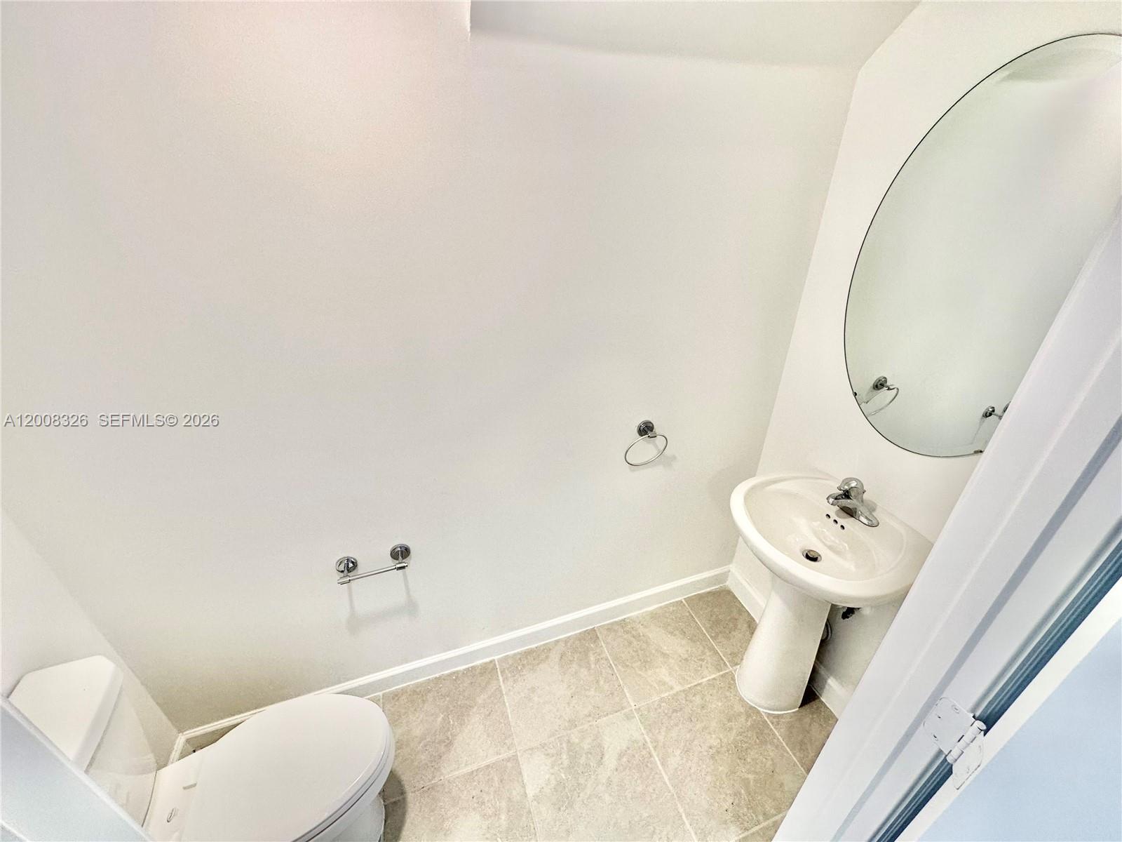 261 Southwest 159th Way Pembroke Pines, FL 33027 - Photo 6 of 17 a bathroom with a sink mirror vanity and toilet