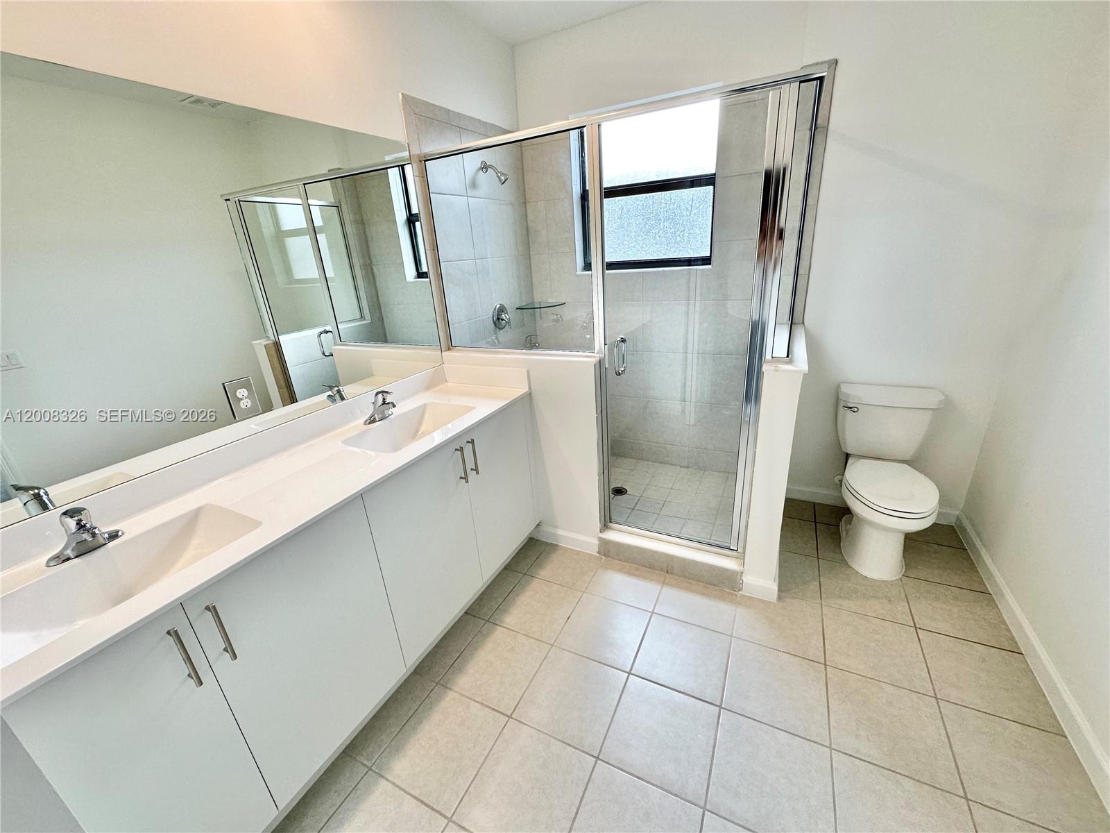 261 Southwest 159th Way Pembroke Pines, FL 33027 - Photo 8 of 17 a bathroom with a double vanity sink toilet and shower