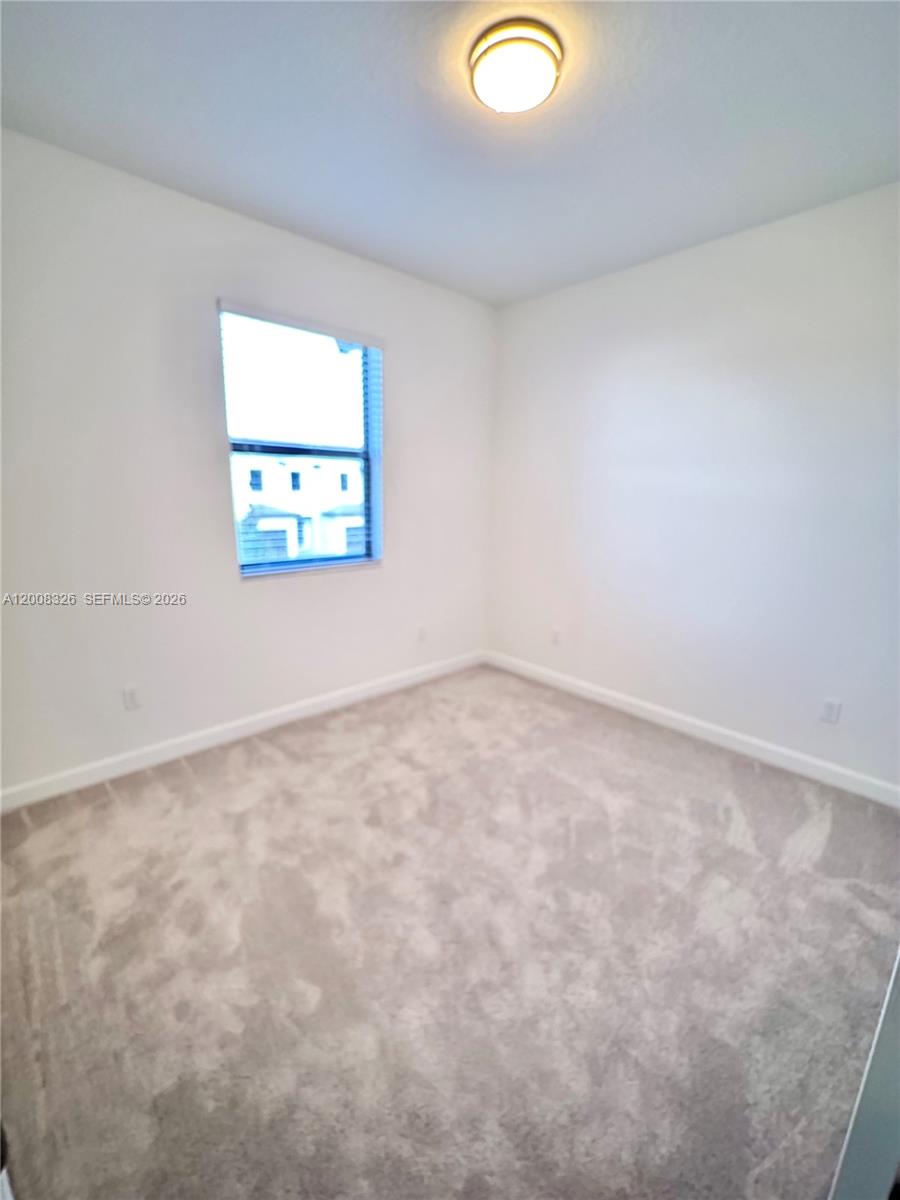 261 Southwest 159th Way Pembroke Pines, FL 33027 - Photo 9 of 17 an empty room with windows