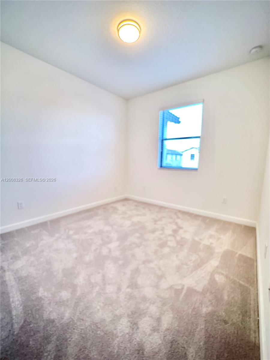 261 Southwest 159th Way Pembroke Pines, FL 33027 - Photo 10 of 17 an empty room with windows