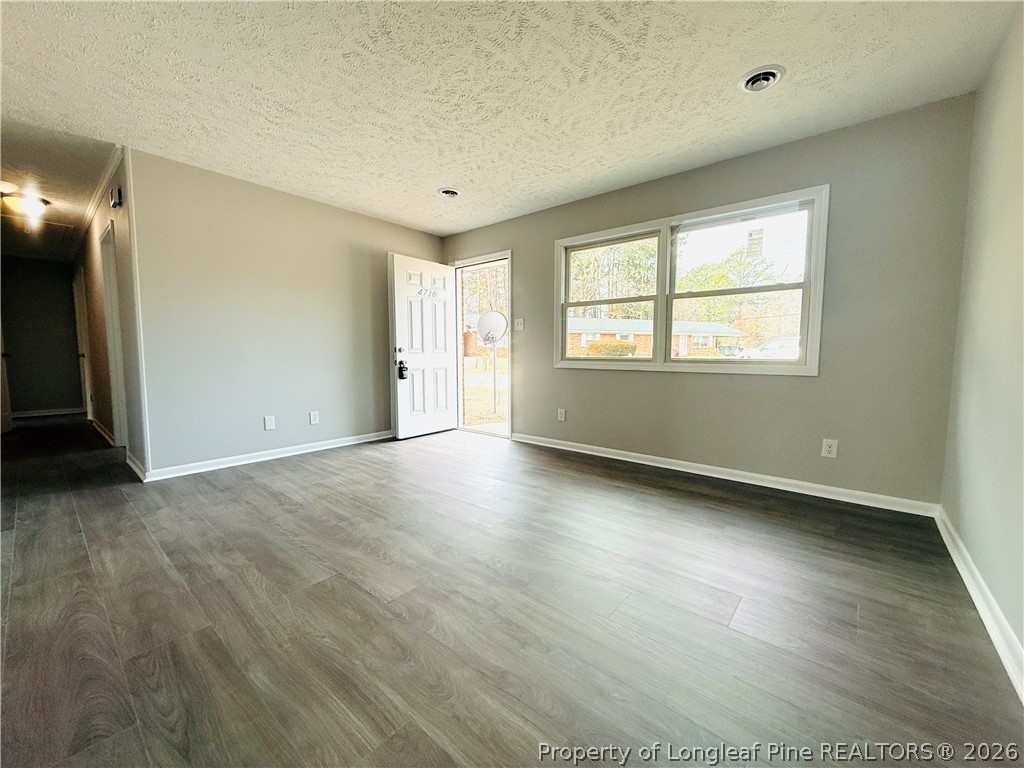 4736 Rosehill Road Fayetteville, NC 28311 - Photo 4 of 15 an empty room with wooden floor and windows