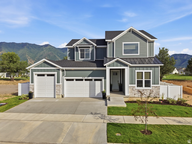 2559 West Aurora Avenue Mapleton, UT 84664 - Photo 1 of 60 Contemporary exterior featuring mixed material siding, stone accents, and a two-car garage