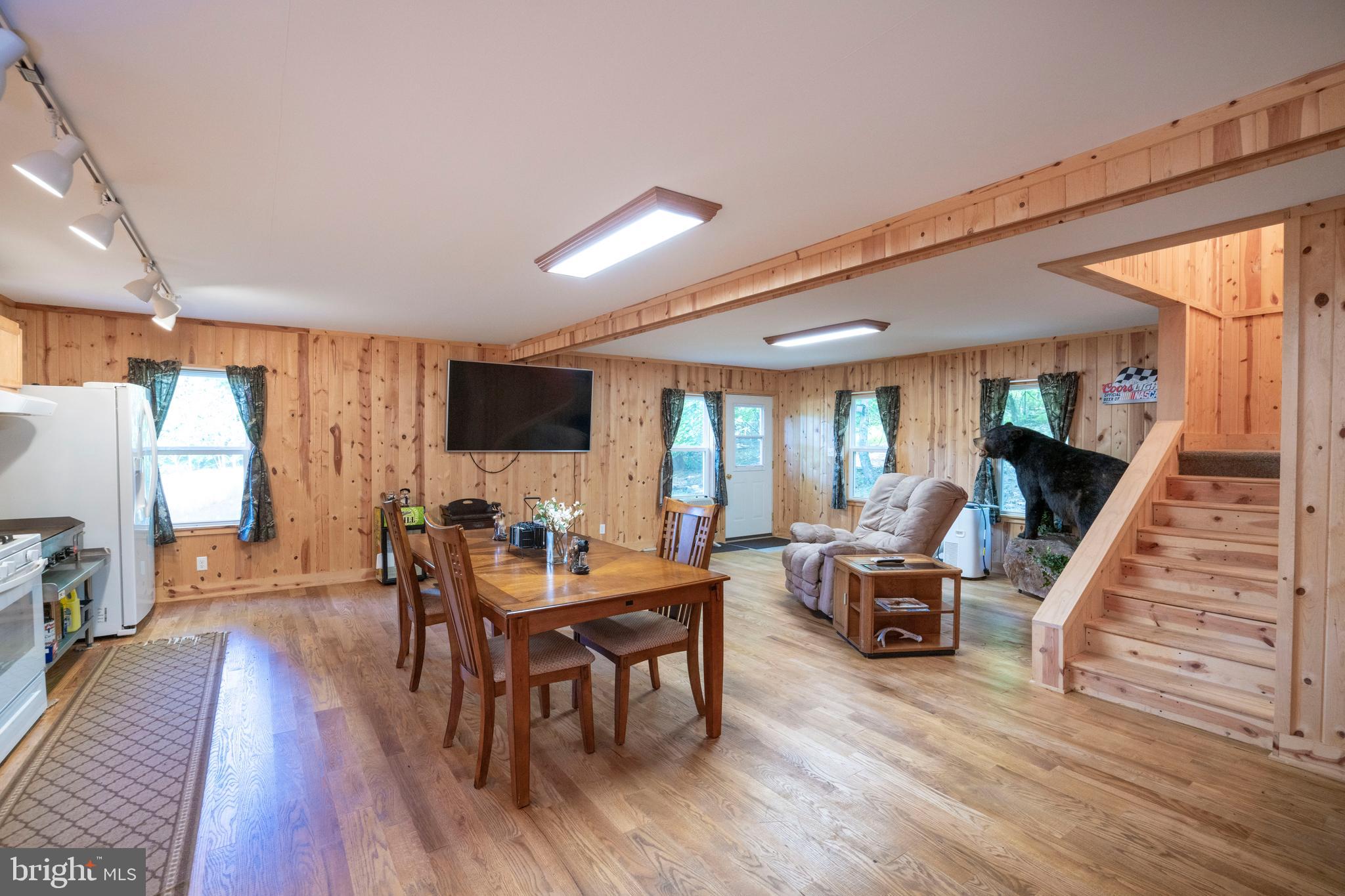 385 Elk Creek Road Aaronsburg, PA 16820 - Photo 27 of 71 a view of a dining room with furniture window and wooden floor