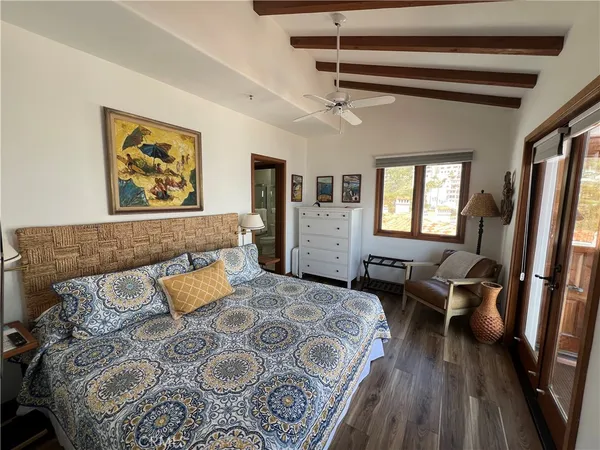 a bedroom with a large bed and a couch