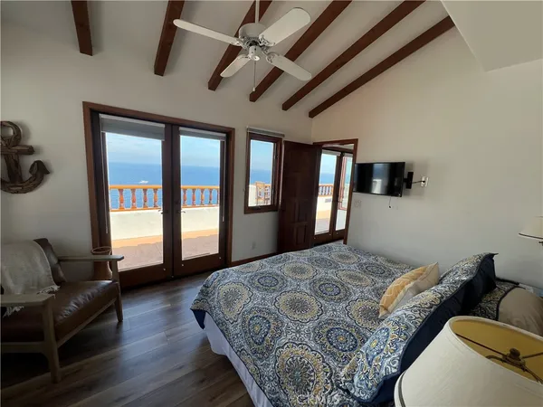 a spacious bedroom with a bed couch and a window