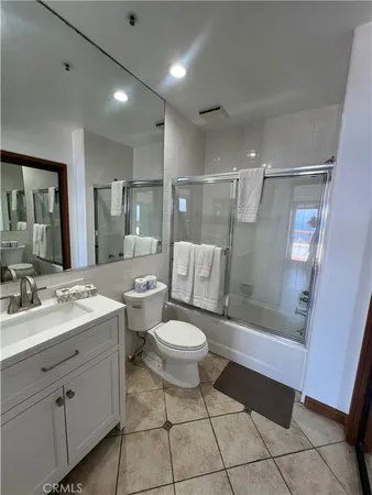 a bathroom with a double vanity sink toilet and shower