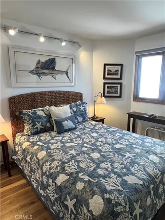 a bedroom with a bed and a painting on the wall