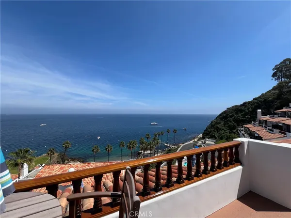 a view of a balcony with wooden fence