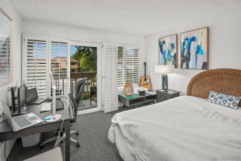 a bedroom with two beds and a large window
