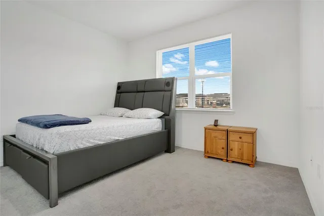 a bedroom with a bed and window