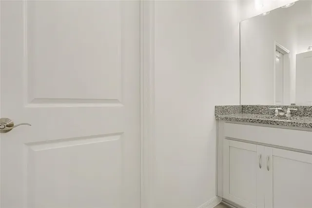 a bathroom with a sink and vanity