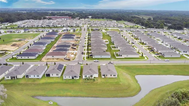 a view of a swimming pool with lawn chairs