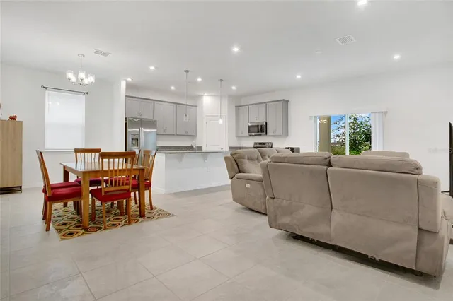 a living room with furniture and kitchen view