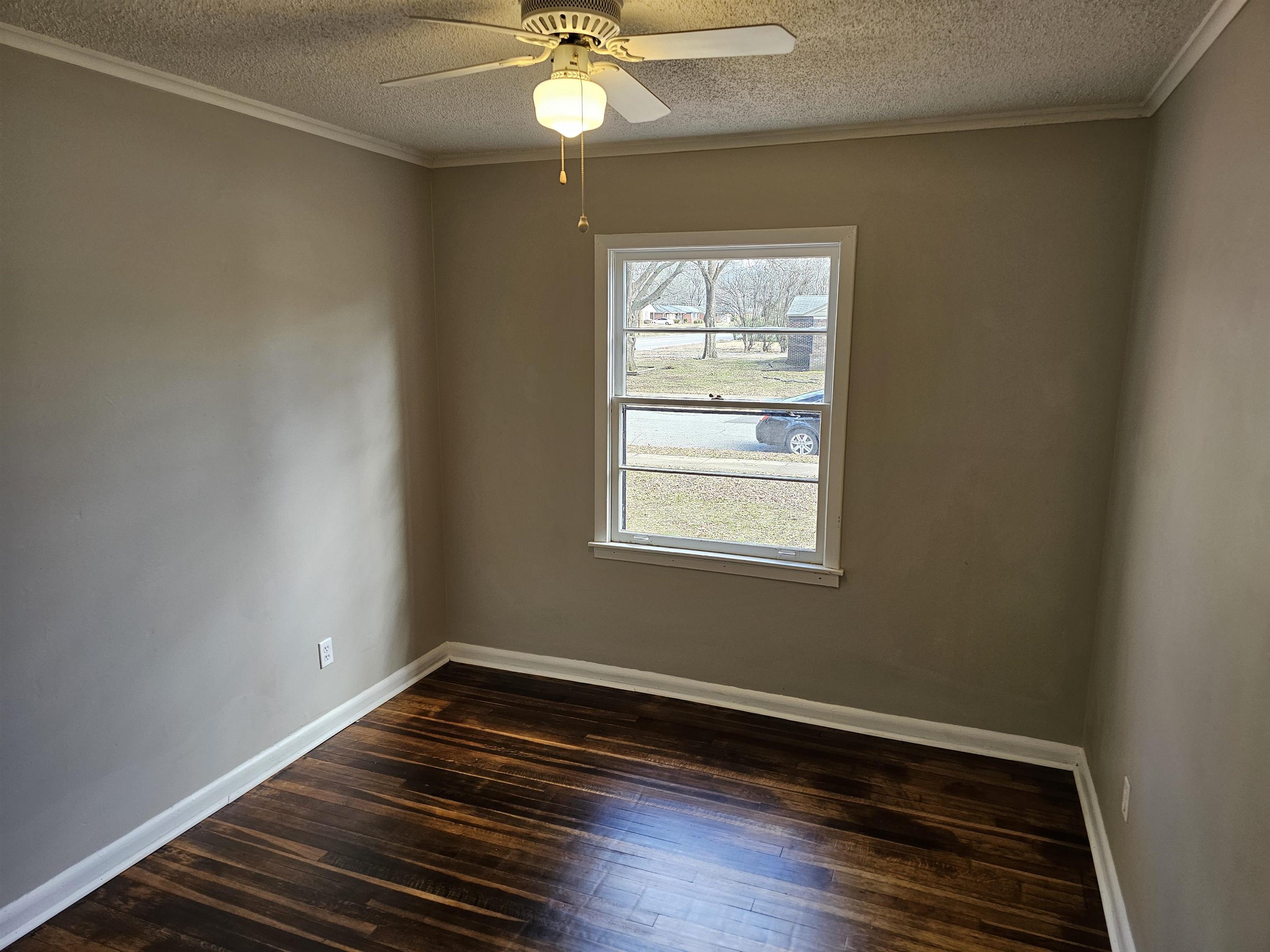 1485 Ivy Road Memphis, TN 38117 - Photo 8 of 22 a view of an empty room with wooden floor and a window