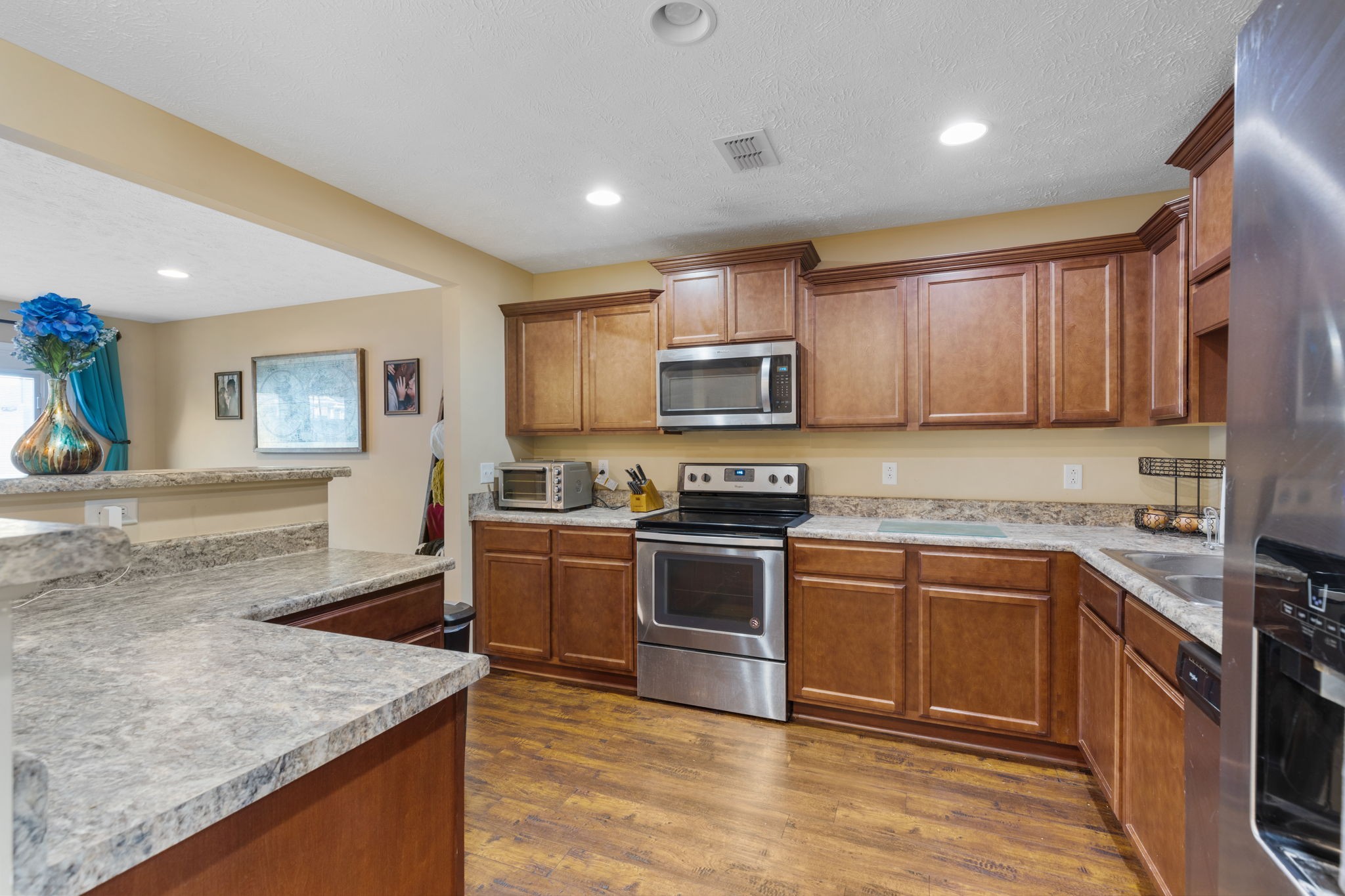 4406 Prometheus Way Murfreesboro, TN 37128 - Photo 7 of 27 a kitchen with stainless steel appliances granite countertop a sink stove microwave and cabinets