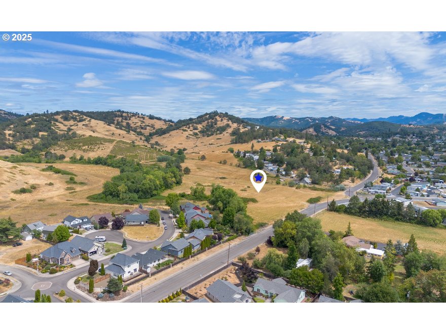 0 Lookingglass Road Winston, OR 97496 - Photo 5 of 5 a view of a city with mountains in the background