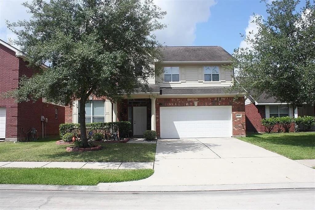 6211 Menor Crest Drive Spring, TX 77388 - Photo 1 of 17 a front view of a house with a garden