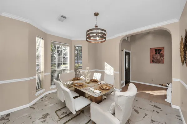 a view of a dining room with furniture window and wooden floor