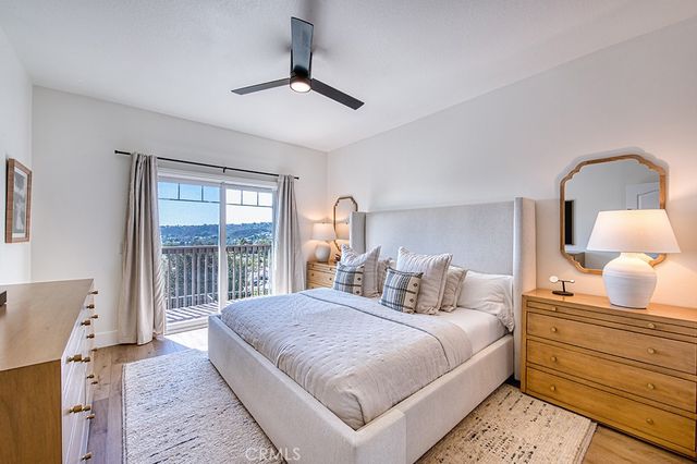 a bedroom with a bed and a large window