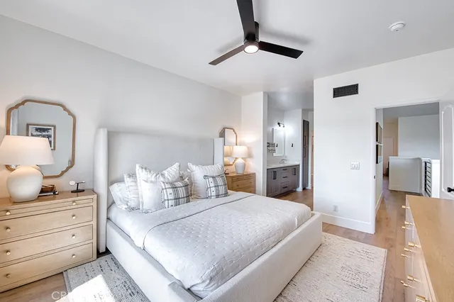 a bedroom with a large bed and a chandelier