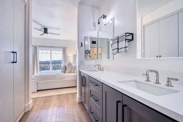 a bathroom with a sink vanity tub and a mirror