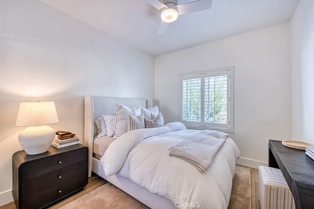 a bedroom with a bed and window with lamp