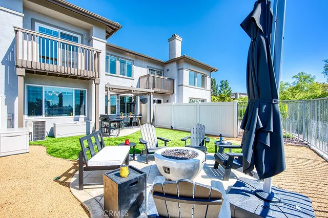 a view of an house with backyard and sitting area