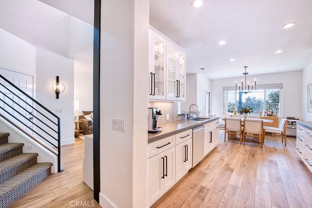 a large kitchen with stainless steel appliances a lot of counter space and wooden floor