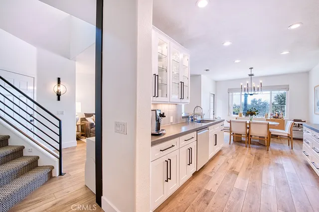 a large kitchen with stainless steel appliances a lot of counter space and wooden floor