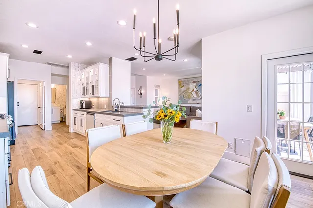 a living room with kitchen island furniture and a chandelier