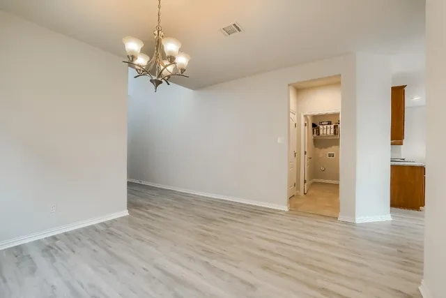 a view of a livingroom with a chandelier fan