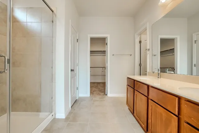 a bathroom with a double vanity sink and a mirror