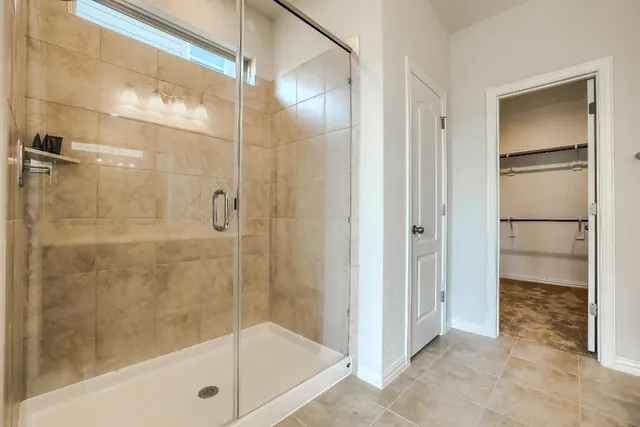 a bathroom with a glass shower door