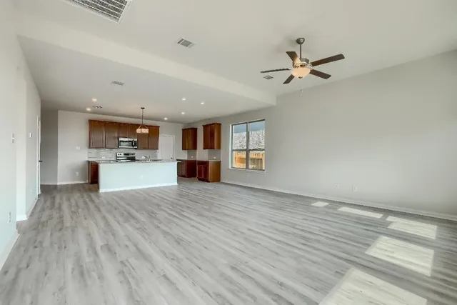 a view of kitchen and hall with wooden floor